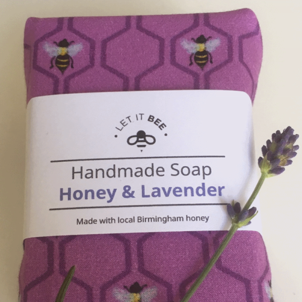 Wrapped bar of Handmade Honey & Lavender Soap, with lavender sprig